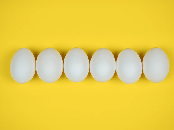 White eggs on a yellow background - Foto, Imagem
