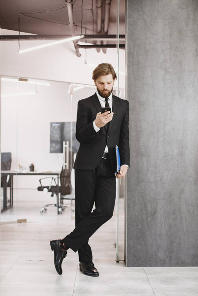 Stylish businessman working in a office - Photo, image