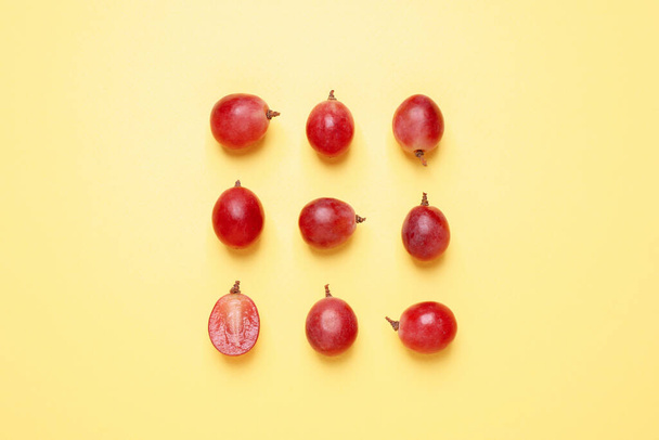 Flat lay composition with fresh ripe grapes on yellow background - Photo, image