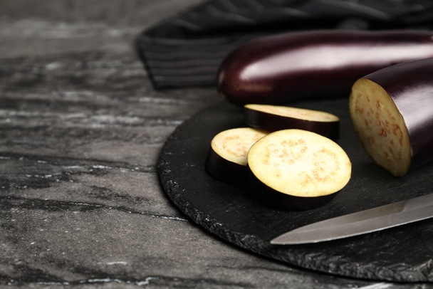 Fresh eggplants on grey table, closeup. Space for text - Photo, Image