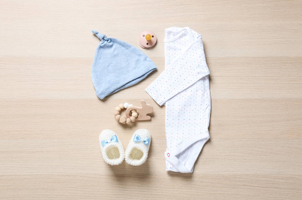 Flat lay composition with cute baby clothes on wooden background - Foto, immagini