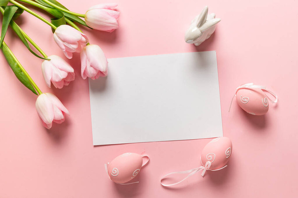 Easter frame with eggs, pink tulips on pink. - 写真・画像