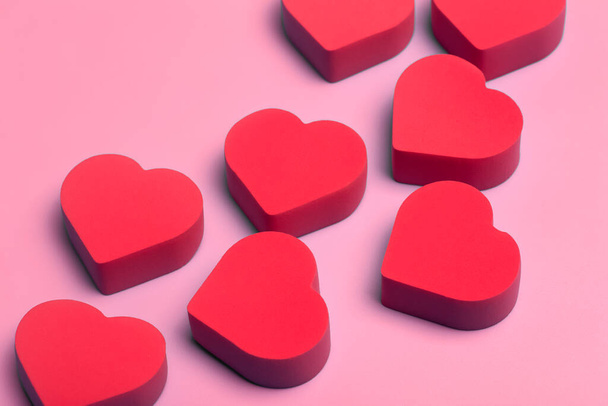 Valentine's day background. Red hearts on a pink minimal background. Love, romance and hearts concept. - Foto, Imagem