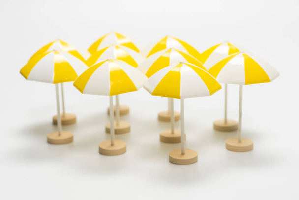 Yellow umbrellas on a white background. Copy space.  - Photo, Image