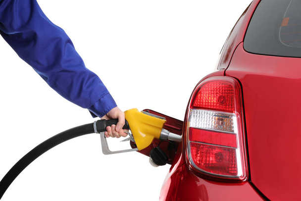 Worker filling up car with fuel on white background, closeup. Gas station - Zdjęcie, obraz