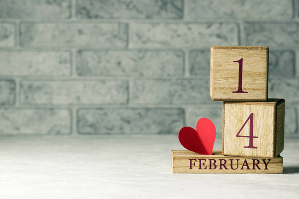 A wooden cubic calendar with a red paper heart. Valentines Day. Copy space. - Photo, Image
