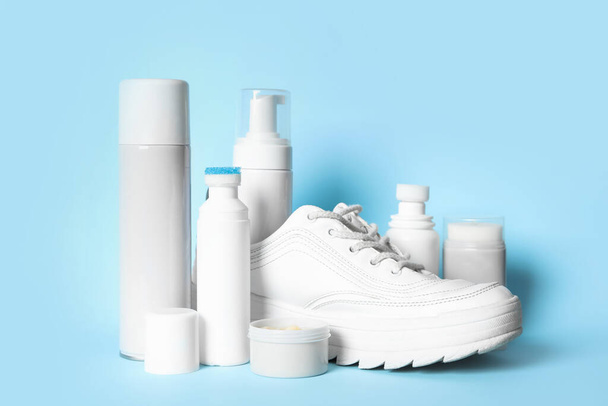 Composition with stylish footwear and shoe care accessories on light blue background - Photo, image
