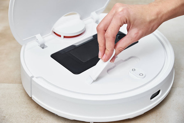 Repair robot vacuum cleaner, close up. Household appliance service - Photo, Image