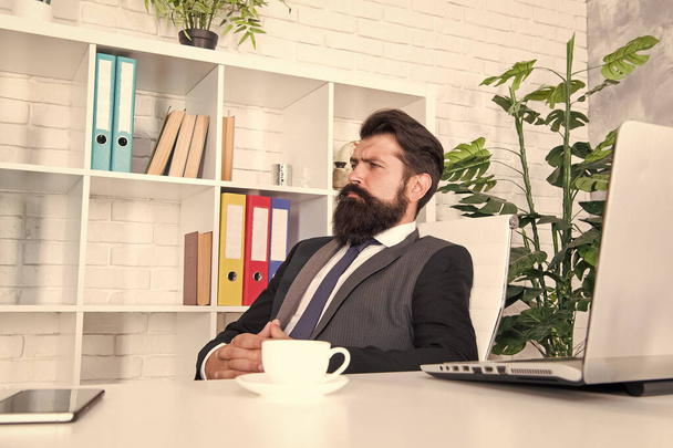 Giving the man confidence. Business man sit at work desk. Bearded man wear fashion suit. Unshaven man with beard and mustache hair. Formal office wear. Fashion and style - Фото, зображення