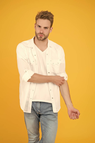 he got great style. portrait of millennial man in casual clothes. Handsome man wear white tshirt and posing in studio. Casually handsome. Casual urban lifestyle. businessman in jeans and shirt - Photo, image