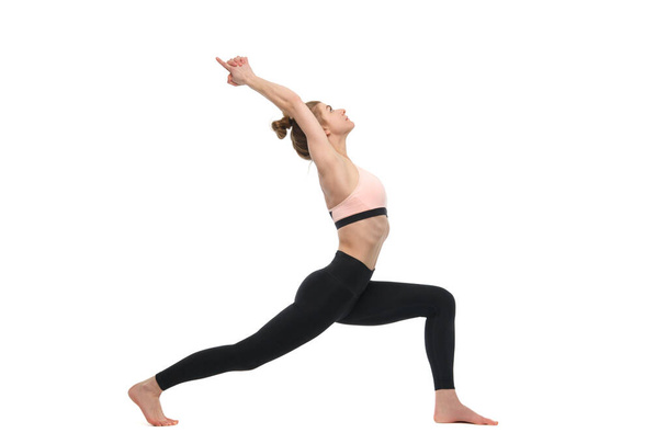 Girl practices yoga isolated on white background. - Zdjęcie, obraz