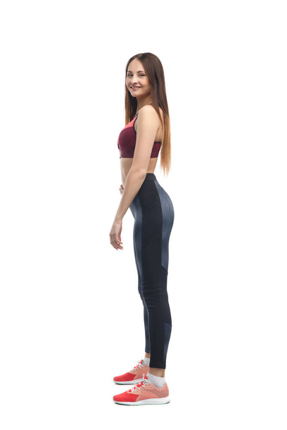 Slim girl athlete isolated on a white background. - Foto, afbeelding
