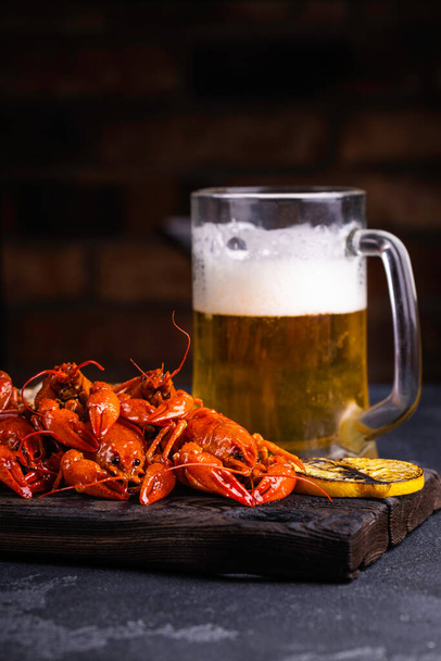 A pile of tasty boiled crawfish. Boiled red crayfish or crawfish with  herbs on a table. Crayfish party, restaurant, cafe, pub menu. - Photo, image