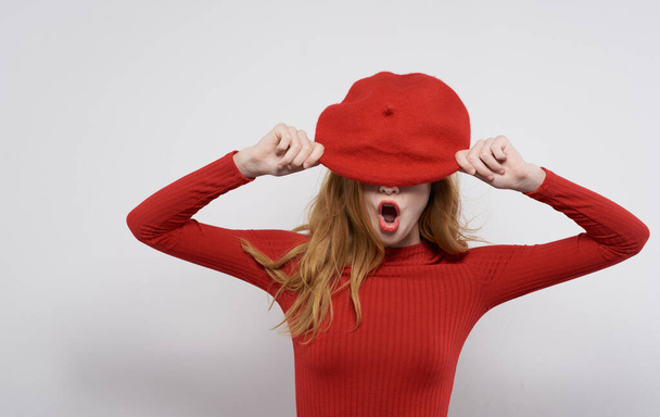 Pretty woman in red dress series wells red hat studio gray background - Fotografie, Obrázek