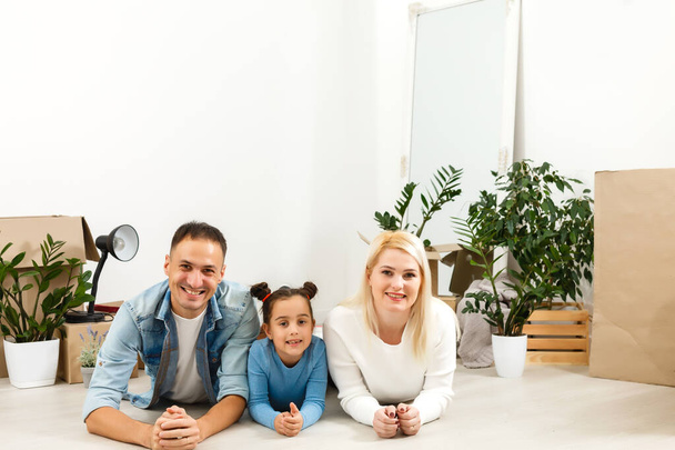 Cheerful couple and their daughter staying at home - Photo, Image