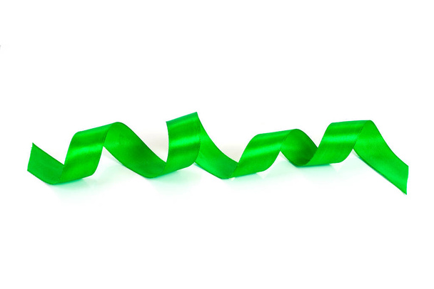 Bright green satin ribbon on white background. - Фото, изображение