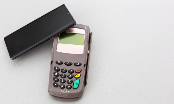 Homme utilisant la technologie NFC sur le téléphone intelligent pour payer la facture - Photo, image