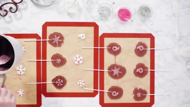 Making homemade berry flavor lollipops with snowflakes. - Footage, Video