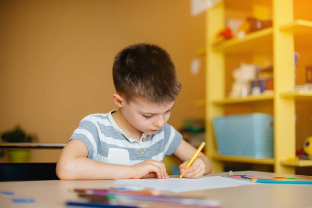 A school-age boy does homework at home. Training at school - Fotografie, Obrázek
