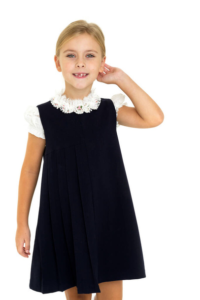 Adorable smiling girl posing in school uniform - Фото, изображение