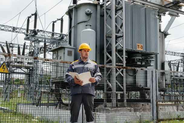 The energy engineer inspects the equipment of the substation. Power engineering. Industry - Valokuva, kuva