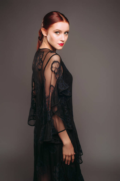 Vestido de noche negro transparente. Hermosa modelo con tacones altos, aspecto femenino moderno para un evento. Moda femenina. Adorable dama.. - Foto, imagen