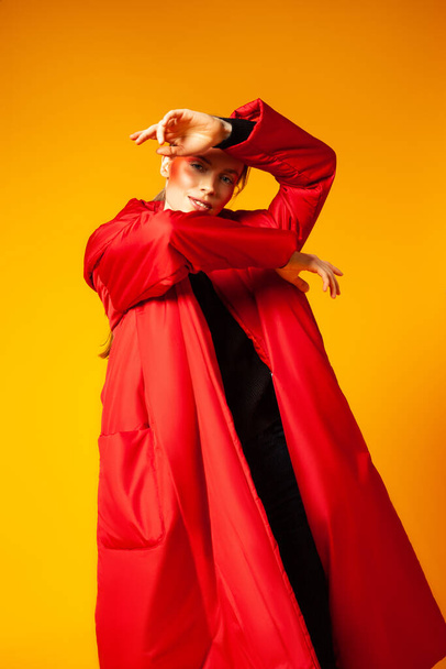 Female model in baggy coat and dancing - Foto, Imagen