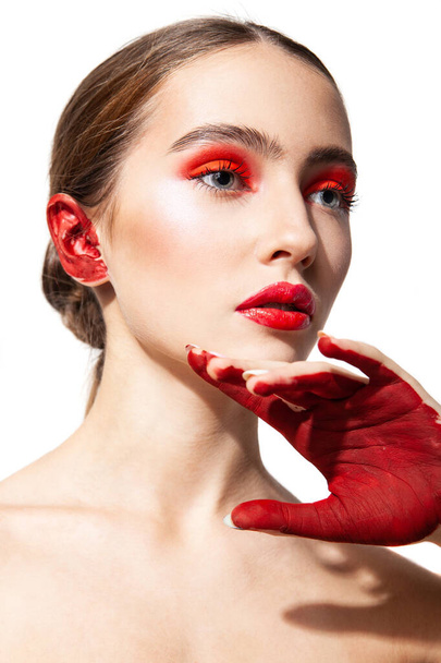 Woman with red makeup and painted hand - Fotografie, Obrázek