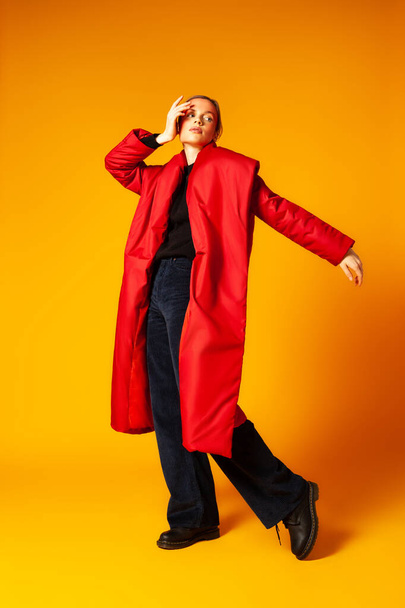Female model in baggy coat and dancing - Foto, Imagem