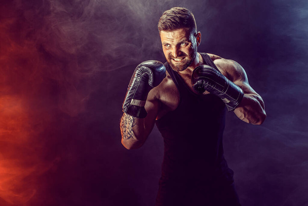 Sportsman boxer fighting on black background with shadow. Copy Space. Boxing sport concept. - Zdjęcie, obraz