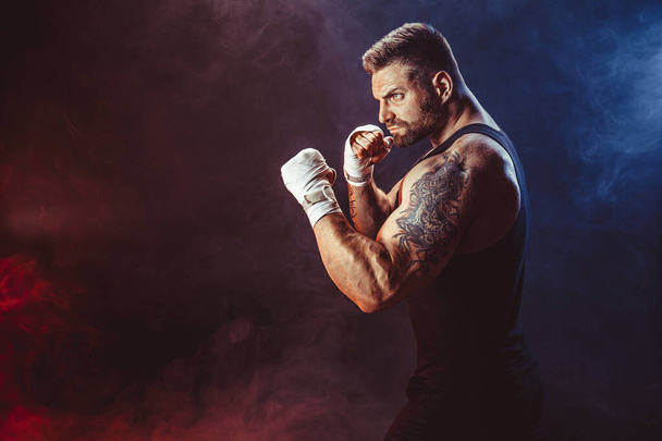Sportsman boxer fighting on black background with shadow. Copy Space. Boxing sport concept. - Foto, imagen