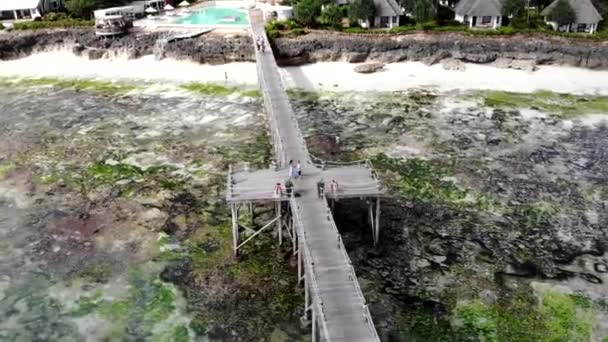 Aerial view of young married couple dancing on wooden bridge on summer vacations. Unforgettable romantic honeymoon of two people, relaxing and enjoying each other on summer resort. Dancing couple at - Felvétel, videó