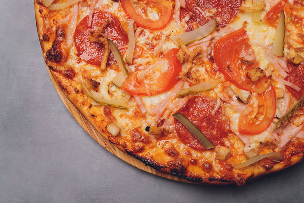 Pizza pepperoni, mozzarella, oregano on a black background. - Fotó, kép