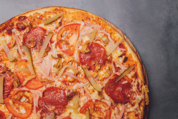 Pizza pepperoni, mozzarella, oregano on a black background. - Photo, Image