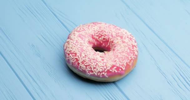 Doce saboroso donut na cor de fundo de madeira  - Filmagem, Vídeo