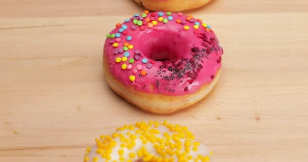 Sweet tasty donuts on wooden background - Footage, Video