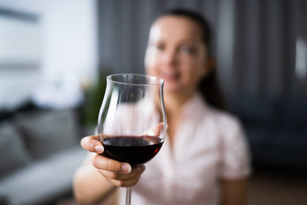 Woman Drinking Red Wine In Video Conference At Home - Valokuva, kuva
