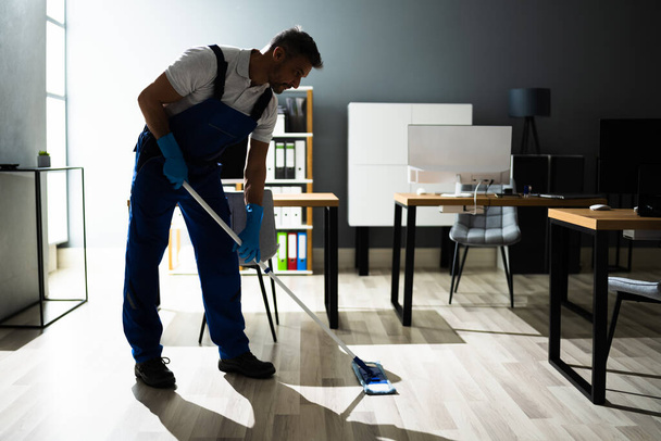 Male Janitor Mopping Floor In Face Mask In Office - Fotó, kép