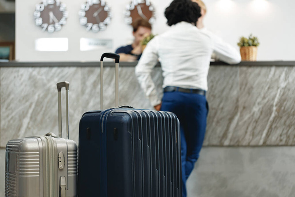Unrecognizable businessman standing with luggage suitcase in hotel lobby - Foto, Imagem