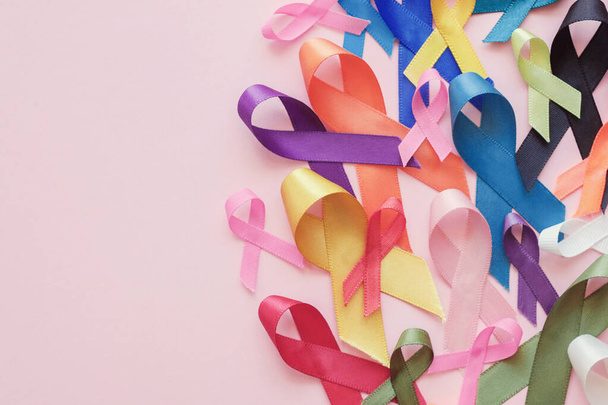All color ribbons on pink background, cancer awareness, World cancer day - Fotografie, Obrázek