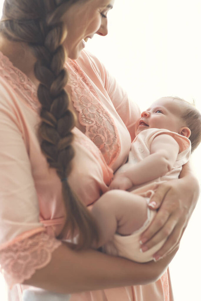 Portrait of a beautiful mother, with her nursing baby. - 写真・画像