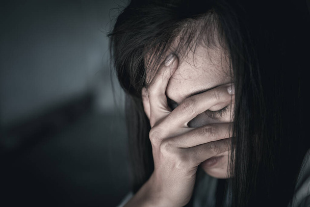 Τρομαγμένη νεαρή γυναίκα που κάθεται στη γωνία της κρεβατοκάμαράς της, απελπισμένη θύμα βιασμού περιμένοντας βοήθεια, η ιδέα να σταματήσει η βία κατά των γυναικών και ο βιασμός.  - Φωτογραφία, εικόνα