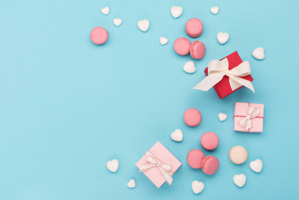 Elegant festive composition for Valentine's day. White glitter hearts, gift box, sweets on blue background. Valentines Day, Happy Women's Day, Mother's day concept. Flat lay, top view, copy space. - Zdjęcie, obraz