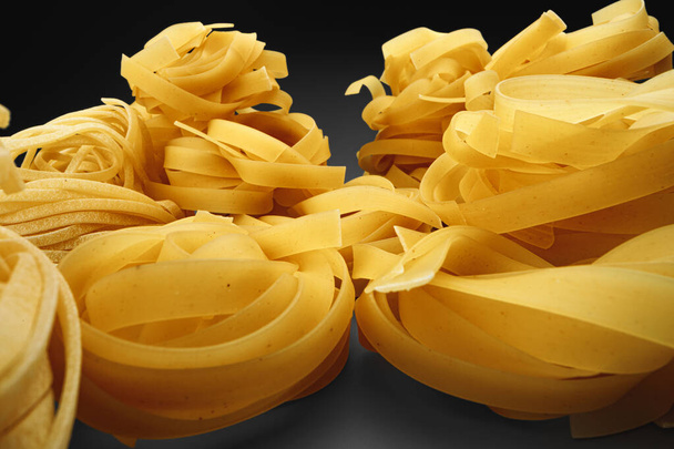 Dry pasta on dark background macro photo - Foto, Imagem