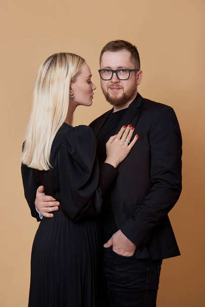 Fashion portrait of a stylish couple in love in black clothes. A man and a woman embrace - Photo, Image