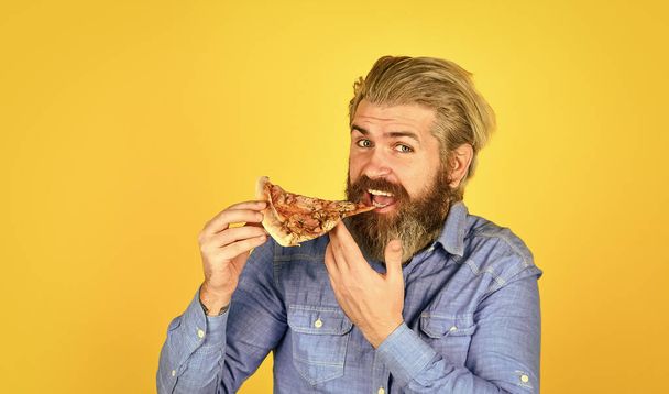 Hold italian pizza slice. man from delivery service. happy bearded man with pizza. italian food. italy is here. bearded male chef cook or baker man - Valokuva, kuva