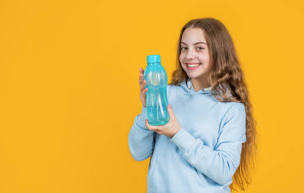 take care of you. athletic kid care of water balance in body. hydration. feel thirsty. protein and vitamin bottle. happy and healthy teen girl. fit child drink water after training. sport is life - Foto, Bild