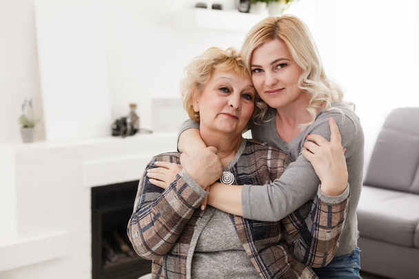 happy senior mother and adult daughter closeup portrait at home - Foto, immagini