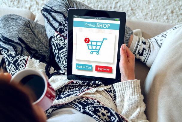 A girl drinks coffee and makes purchases in an online store using a tablet. Online Shopping Concept - Foto, Imagem
