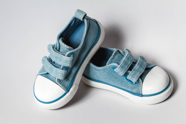 Cute baby blue gym shoes isolated on white background - Φωτογραφία, εικόνα